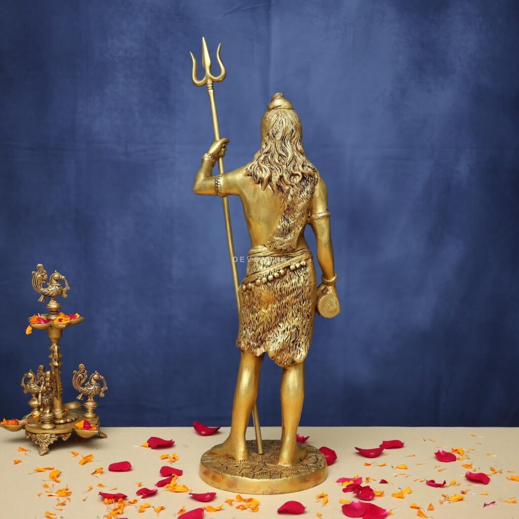 standing brass shiva idol holding a big trishul