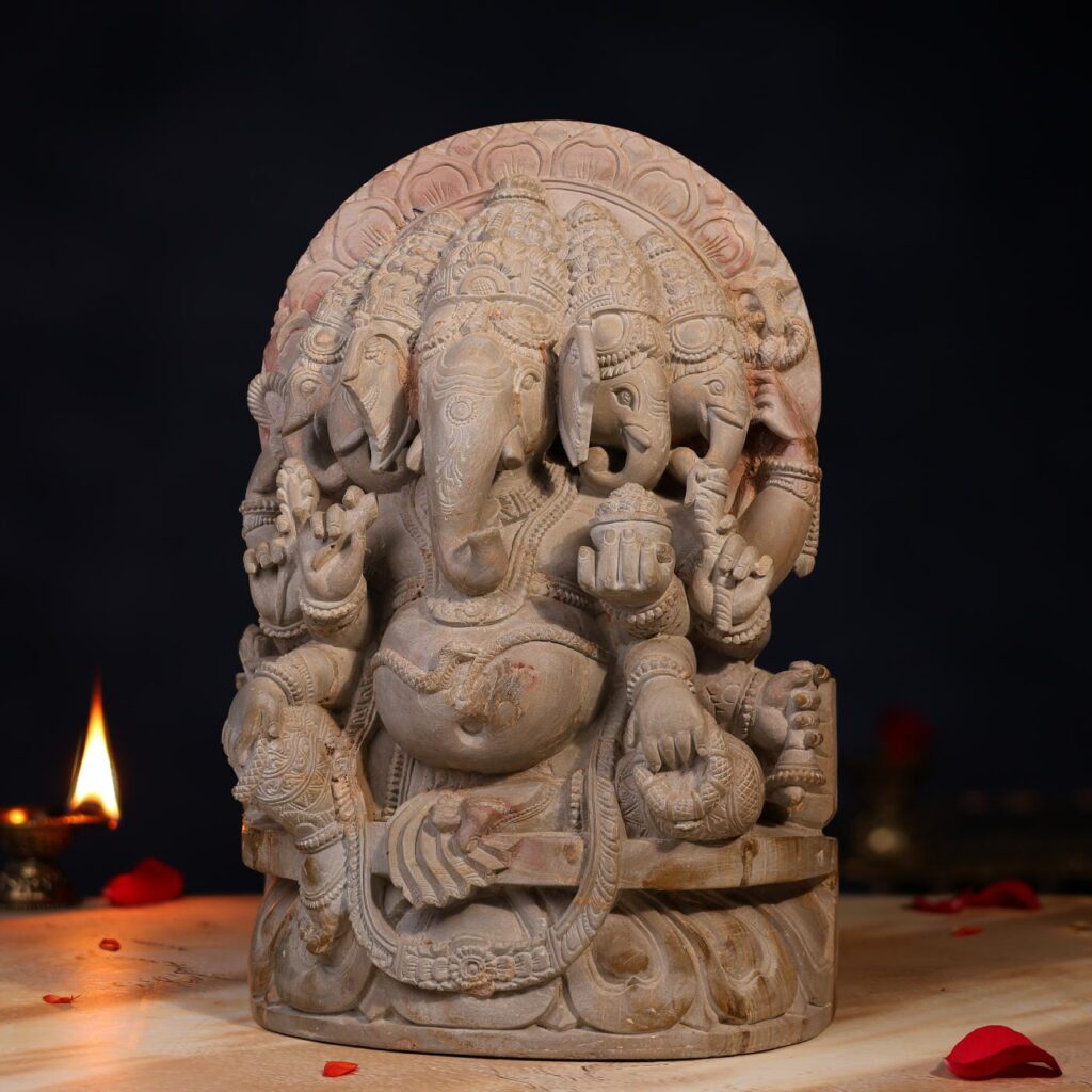 side view of handcrafted Stone Panchmukhi Ganesh Idol, 1 feet height, detailed carving. Caption: Left side profile of the 1 feet Stone Panchmukhi Ganesh Idol.