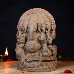 side view of handcrafted Stone Panchmukhi Ganesh Idol, 1 feet height, detailed carving. Caption: Left side profile of the 1 feet Stone Panchmukhi Ganesh Idol.