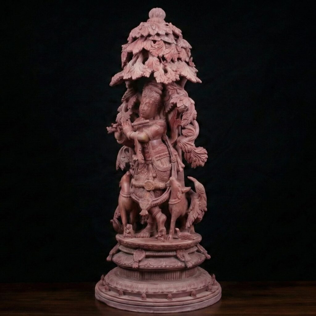 Pink stone Krishna idol with cows and peacock carving