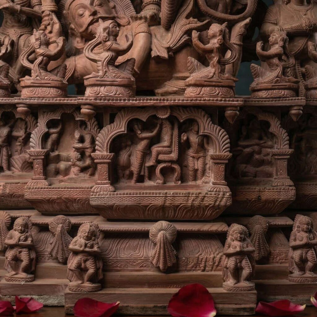 base carving detail of pink stone nataraja statue temple style sculpture