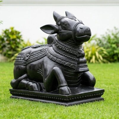 Front view of a seated bull statue with intricate designs, Black Stone Nandi Idol.