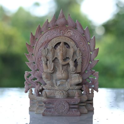 pink stone ganesh murti sitting on throne